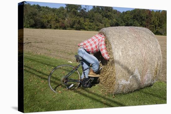 Bike Riding into Hay Bail-null-Stretched Canvas