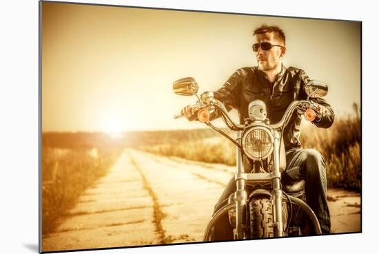 Biker Man Sits on a Bike-Andrey Armyagov-Mounted Photographic Print