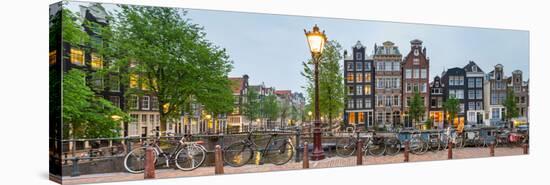 Bikes and Houses Along Canal at Dusk at Intersection of Herengracht and Brouwersgracht-null-Stretched Canvas