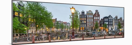 Bikes and Houses Along Canal at Dusk at Intersection of Herengracht and Brouwersgracht-null-Mounted Photographic Print