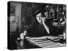 Bill Graham, Owner of Filmores East and West, Talking on Phone as He Works in His Office-John Olson-Stretched Canvas