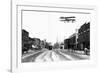Biplane over a Small Town-J.H. Cave-Framed Photographic Print