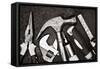 Black and White Image of a Set of Tools on a Textured Metallic Background-Kamira-Framed Stretched Canvas