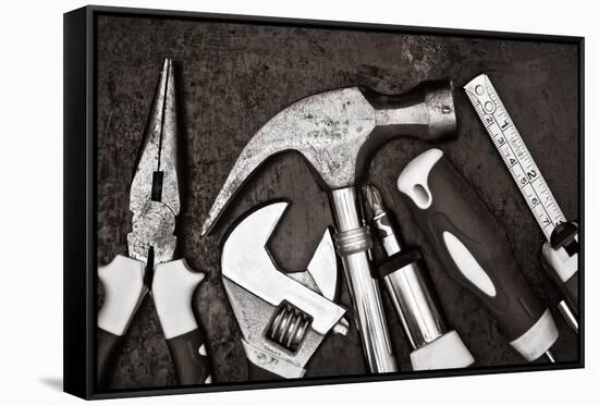 Black and White Image of a Set of Tools on a Textured Metallic Background-Kamira-Framed Stretched Canvas