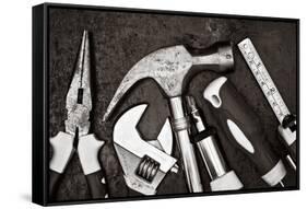 Black and White Image of a Set of Tools on a Textured Metallic Background-Kamira-Framed Stretched Canvas