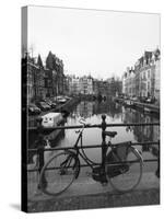 Black and White Image of an Old Bicycle by the Singel Canal, Amsterdam, Netherlands, Europe-Amanda Hall-Stretched Canvas