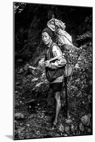 Black and white picture of a Sherpa carrying meat up to Everest Base Camp in Nepal-David Chang-Mounted Photographic Print