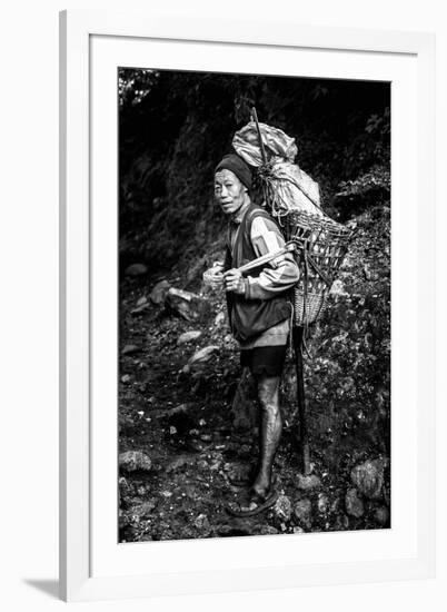 Black and white picture of a Sherpa carrying meat up to Everest Base Camp in Nepal-David Chang-Framed Photographic Print