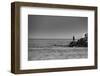 Black and White shot of a lone fisherman on rocks at the beach-null-Framed Photo