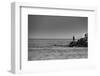 Black and White shot of a lone fisherman on rocks at the beach-null-Framed Photo