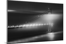 Black And White View Of The Golden Gate Bridge At Night With Silky Low Fog Around The Tower-Joe Azure-Mounted Photographic Print