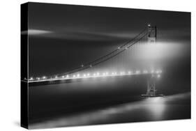 Black And White View Of The Golden Gate Bridge At Night With Silky Low Fog Around The Tower-Joe Azure-Stretched Canvas