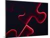 Black Puzzle with Red Light Shining Through the Cracks-null-Mounted Photographic Print