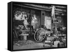 Blacksmith Working in His Shop-John Phillips-Framed Stretched Canvas