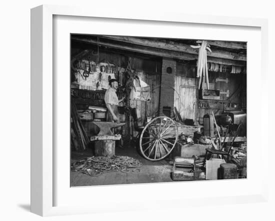 Blacksmith Working in His Shop-John Phillips-Framed Photographic Print