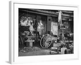 Blacksmith Working in His Shop-John Phillips-Framed Photographic Print