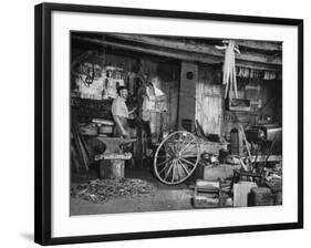 Blacksmith Working in His Shop-John Phillips-Framed Photographic Print