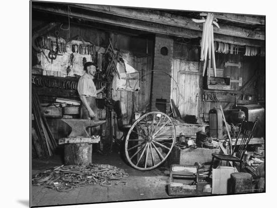 Blacksmith Working in His Shop-John Phillips-Mounted Photographic Print