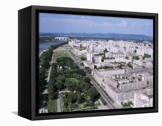 Blocks of Flats Beside Taedong River, Park and Distant Mayday Stadium, Pyongyang, North Korea-Tony Waltham-Framed Stretched Canvas