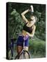 Blond Bicyclist Cooling Off with Bottled Water-null-Stretched Canvas