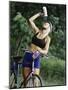 Blond Bicyclist Cooling Off with Bottled Water-null-Mounted Photographic Print