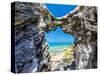 Blue and turquoise Sargasso Sea, glimpsed through an arch in the island's distinctive rocks-Barry Davis-Stretched Canvas