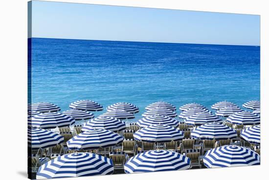 Blue and white beach parasols, Nice, Alpes Maritimes, Cote d'Azur, Provence, France, Mediterranean,-Fraser Hall-Stretched Canvas