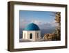Blue domed Greek Orthodox church with bougainvillea flowers in Oia, Santorini, Greece.-Michele Niles-Framed Photographic Print