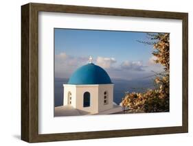 Blue domed Greek Orthodox church with bougainvillea flowers in Oia, Santorini, Greece.-Michele Niles-Framed Photographic Print