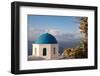 Blue domed Greek Orthodox church with bougainvillea flowers in Oia, Santorini, Greece.-Michele Niles-Framed Photographic Print