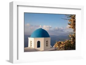 Blue domed Greek Orthodox church with bougainvillea flowers in Oia, Santorini, Greece.-Michele Niles-Framed Photographic Print