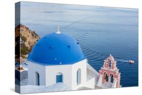 Blue domed white church overlooking boat in Aegean Sea, Santorini, Cyclades-Ed Hasler-Stretched Canvas