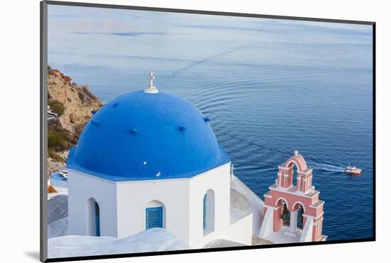 Blue domed white church overlooking boat in Aegean Sea, Santorini, Cyclades-Ed Hasler-Mounted Photographic Print