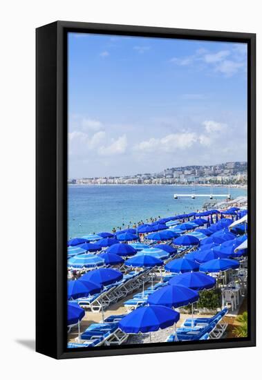 Blue parasols on the beach, Promenade des Anglais, Nice, Alpes Maritimes, Cote d'Azur, Provence, Fr-Fraser Hall-Framed Stretched Canvas