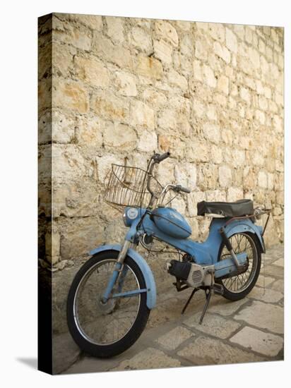 Blue scooter bike by old stone wall, Hvar Town, Hvar Island, Dalmatia, Croatia-Merrill Images-Stretched Canvas