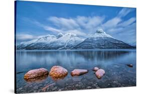 Blue sky at dusk and snowy peaks are reflected in the frozen sea at Oteren Storfjorden Lapland Lyng-ClickAlps-Stretched Canvas