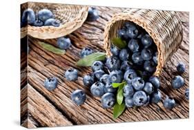 Blueberries Have Dropped from the Basket on an Old Wooden Table.-Volff-Stretched Canvas