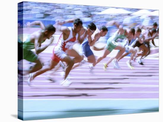 Blured Action at the Start of a Mens 100 Meter Track and Field Race-Paul Sutton-Stretched Canvas