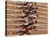 Blurred Action of Male Runners Starting a 100 Meter Sprint Race-Paul Sutton-Stretched Canvas