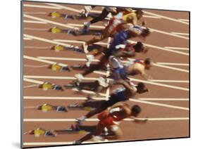 Blurred Action of Male Runners Starting a 100 Meter Sprint Race-Paul Sutton-Mounted Photographic Print