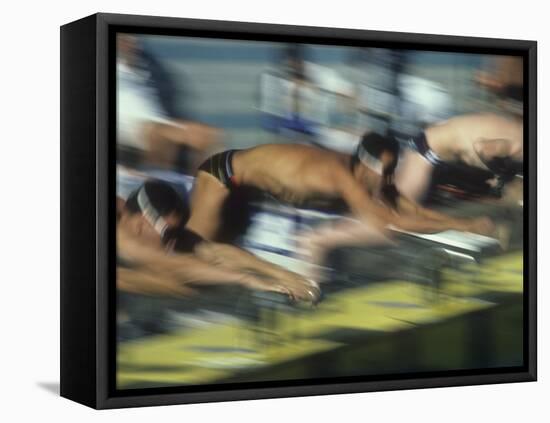 Blurred Action of Male Swimmers at the Start of a Race-null-Framed Stretched Canvas