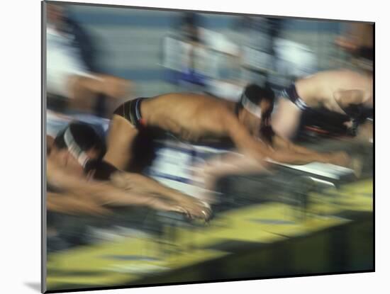 Blurred Action of Male Swimmers at the Start of a Race-null-Mounted Photographic Print