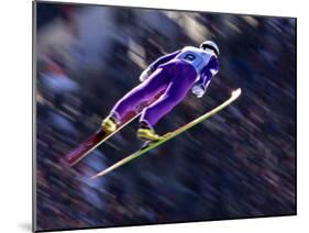 Blurred Action of Ski Jumper Flying Throught the Air-null-Mounted Photographic Print