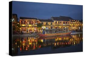 Boat and restaurants reflected in Thu Bon River at dusk, Hoi An, Vietnam-David Wall-Stretched Canvas