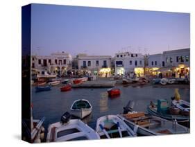 Boats in Harbour at Dusk, with Shops and Restaurants of Mykonos Town in the Background, Greece-Fraser Hall-Stretched Canvas