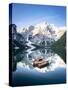 Boats moored in Lake Braies (Pragser Wildsee) with mountains reflected in water-Roberto Moiola-Stretched Canvas