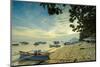 Boats off the town beach at sunset with Manadotua Island beyond, Bunaken, North Sulawesi-Robert Francis-Mounted Photographic Print