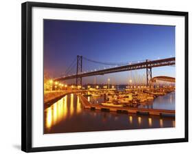 Boats on the River Tagus Move at Night in the Doca De Santa Amaro Marina under the 25 April Bridge,-Stuart Forster-Framed Photographic Print