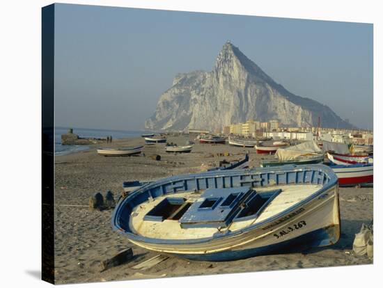 Boats Pulled onto Beach Below the Rock of Gibraltar, Gibraltar-Charles Bowman-Stretched Canvas