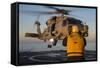 Boatswain's Mate Guides an Mh-60R Sea Hawk onto the Flight Deck-null-Framed Stretched Canvas